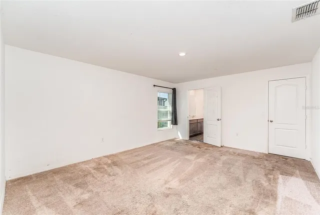 a view of empty room with windows