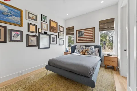 a bedroom with a bed and a painting on the wall