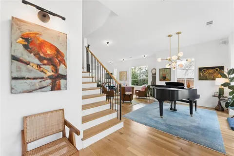 a living room with furniture and a chandelier