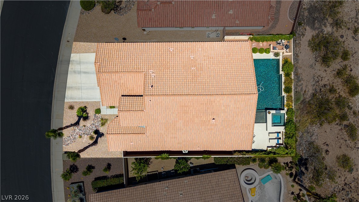 2256 Dogwood Ranch Avenue Henderson, NV 89052 - Photo 8 of 51 An aerial perspective showcases a vibrant pool and relaxing spa, perfectly complemented by a well-maintained desert landscape.