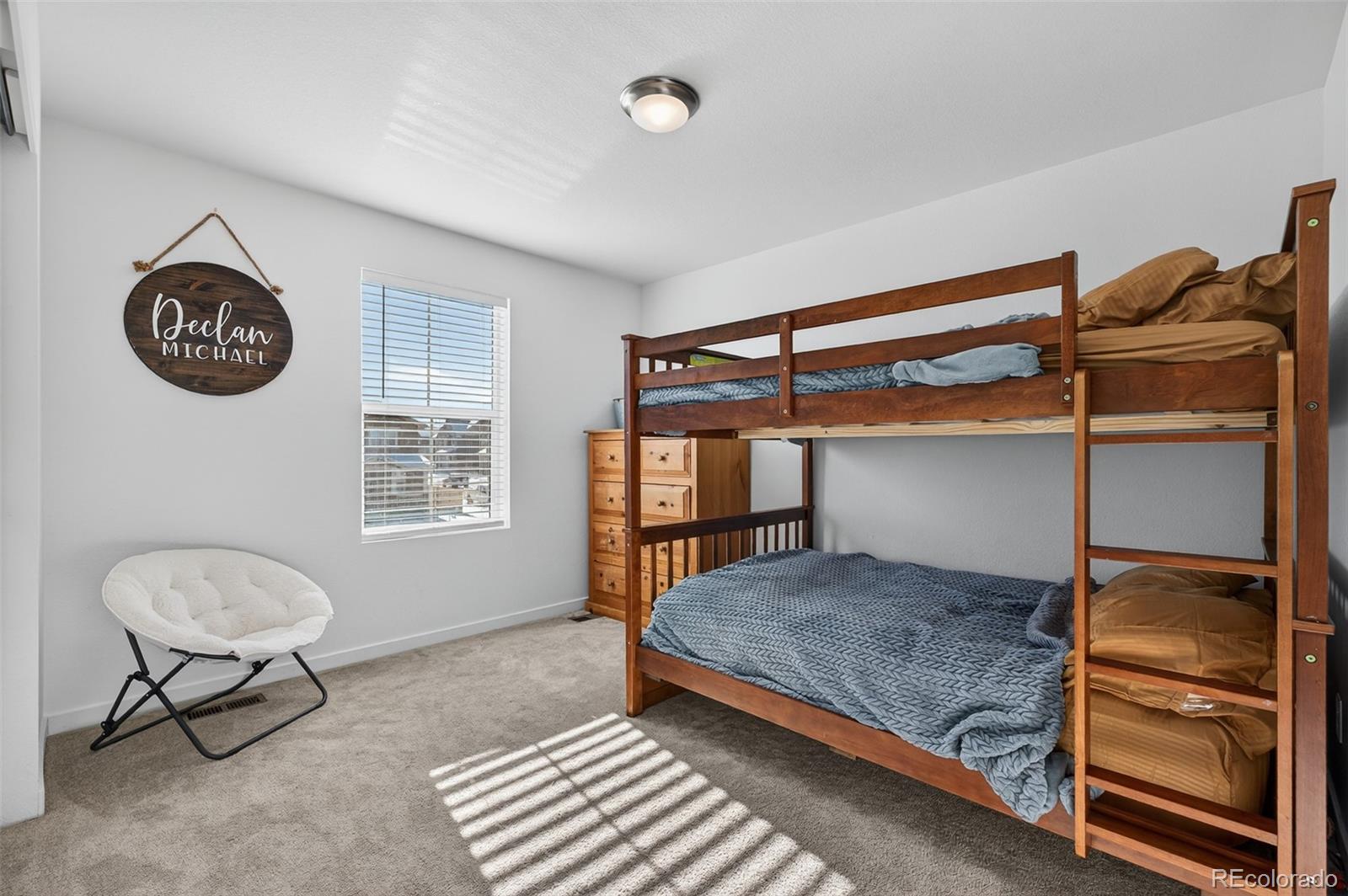 233 Corkscrew Street Elizabeth, CO 80107 - Photo 11 of 33 a bedroom with a bed and a window