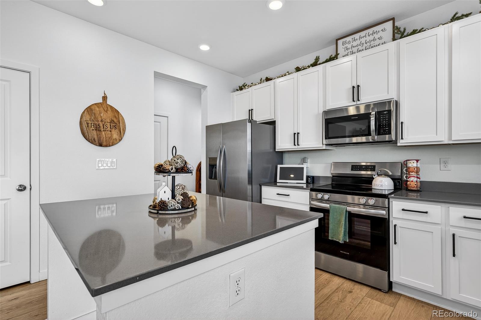 233 Corkscrew Street Elizabeth, CO 80107 - Photo 15 of 33 a kitchen with stainless steel appliances granite countertop a sink stove and refrigerator