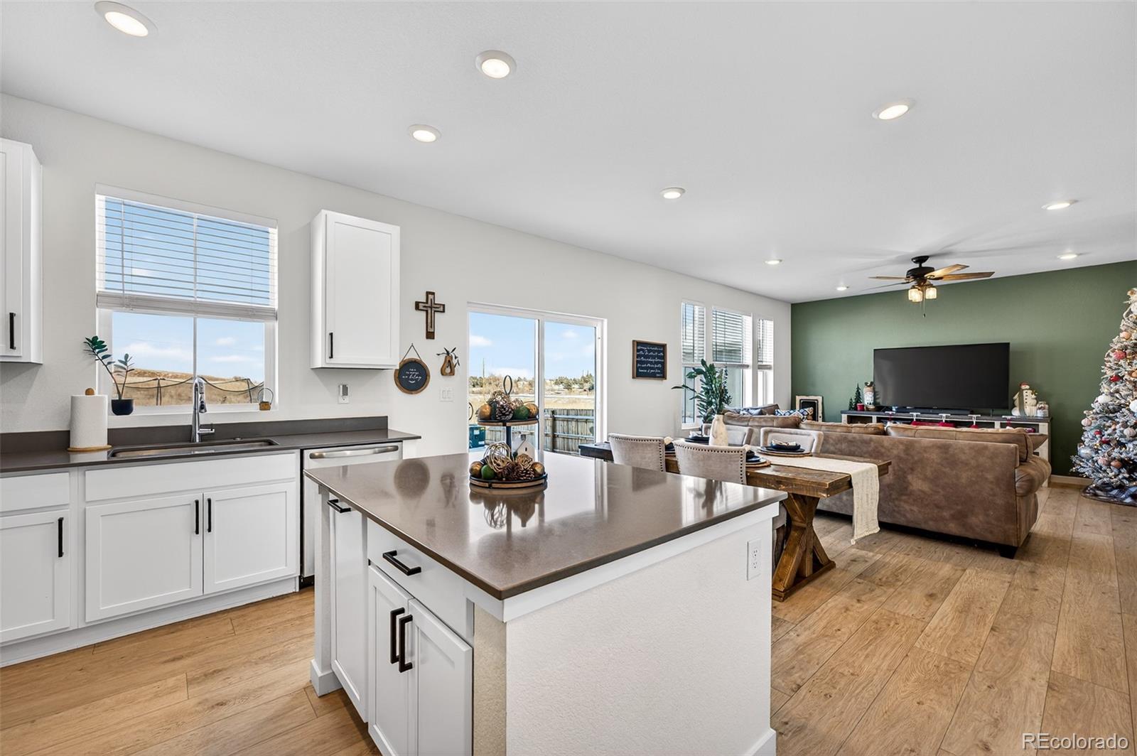 233 Corkscrew Street Elizabeth, CO 80107 - Photo 17 of 33 a kitchen with sink a counter top space and living room view