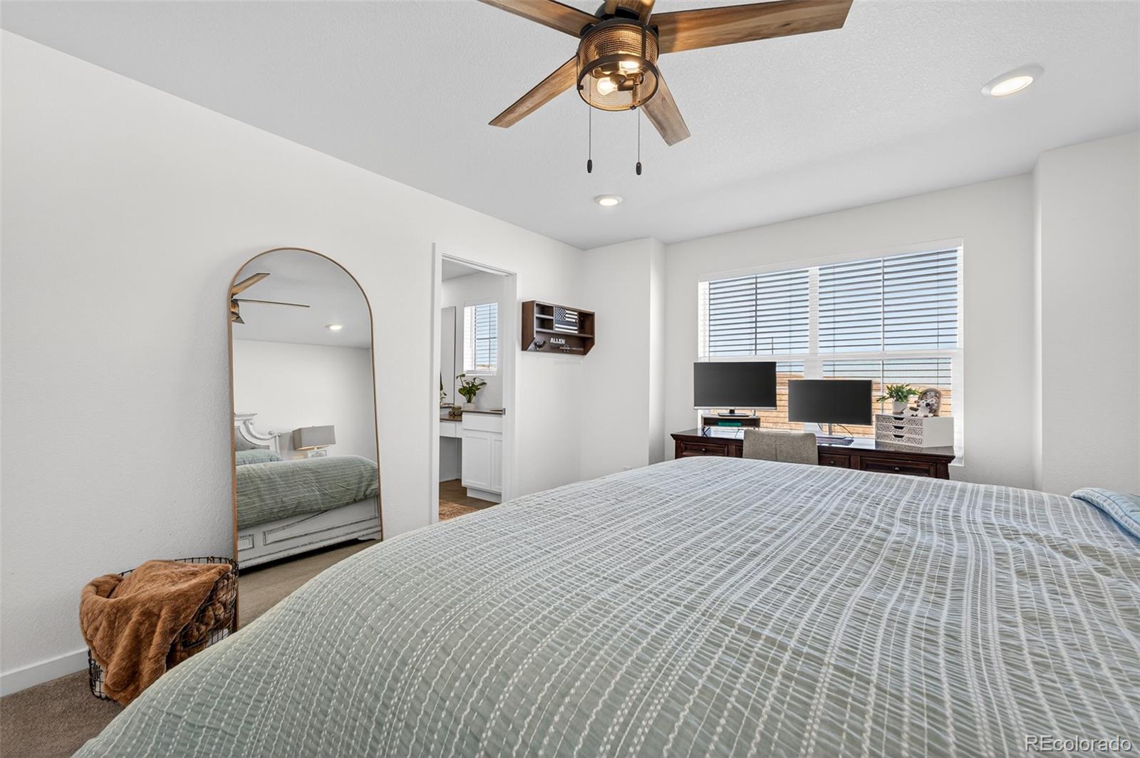 233 Corkscrew Street Elizabeth, CO 80107 - Photo 19 of 33 a bedroom with a bed and a chandelier