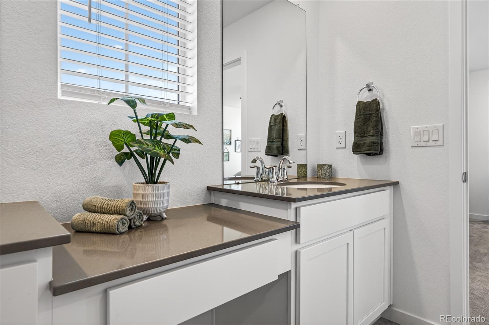 233 Corkscrew Street Elizabeth, CO 80107 - Photo 20 of 33 a bathroom with a sink a vanity and a mirror