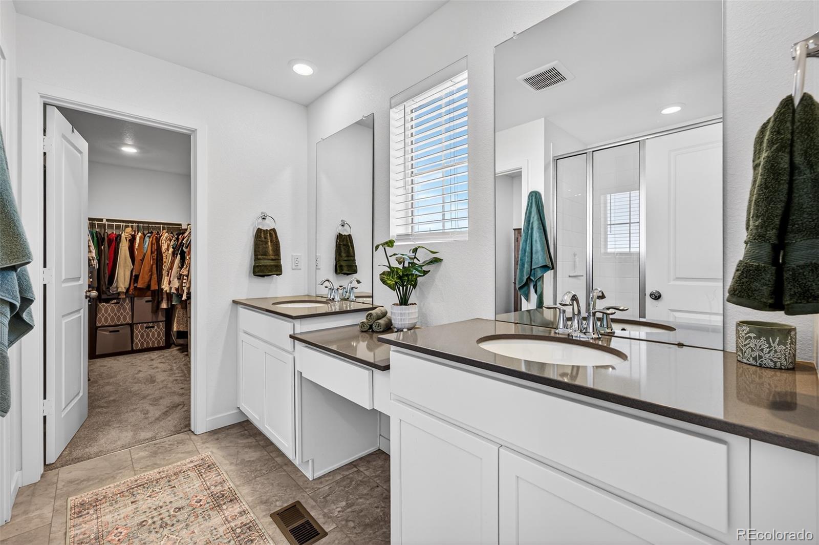 233 Corkscrew Street Elizabeth, CO 80107 - Photo 9 of 33 a spacious bathroom with a double vanity sink and a mirror