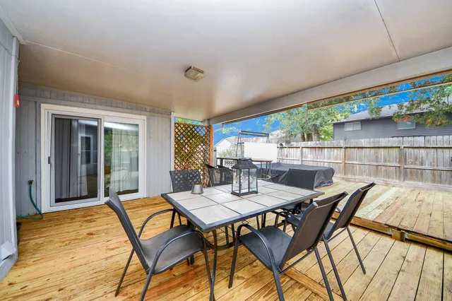 a view of an outdoor dining space with a table and chairs