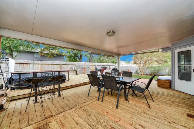 a view of a patio with table and chairs