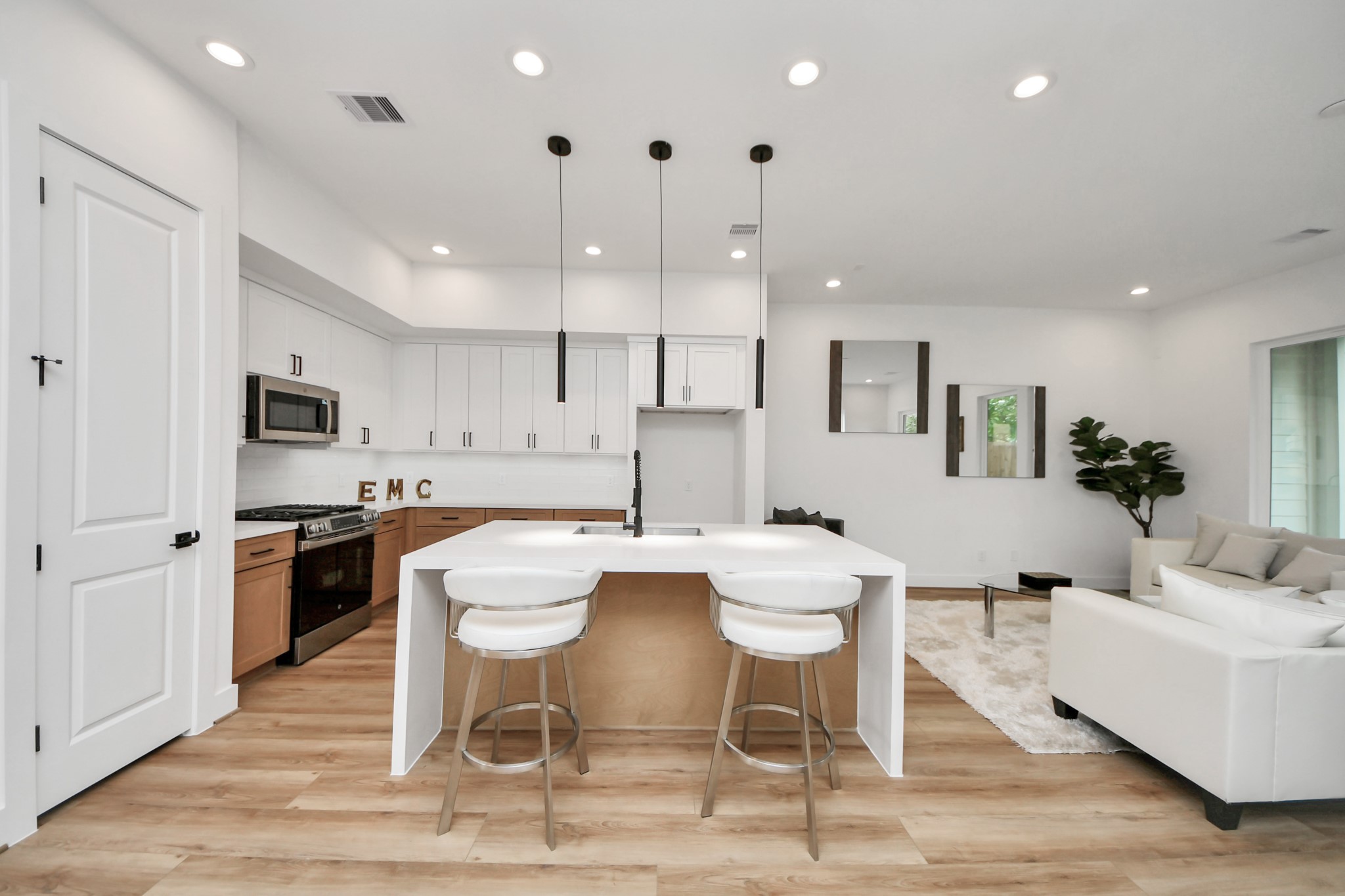 505 Middle Street Houston, TX 77003 - Photo 6 of 46 This kitchen boasts a sleek, modern design with elegant pendant lighting, a spacious island perfect for gathering, and seamless integration into the open-concept living area, creating an inviting and stylish heart for your home.