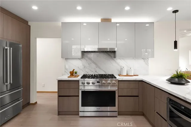 a kitchen with a stove and a refrigerator