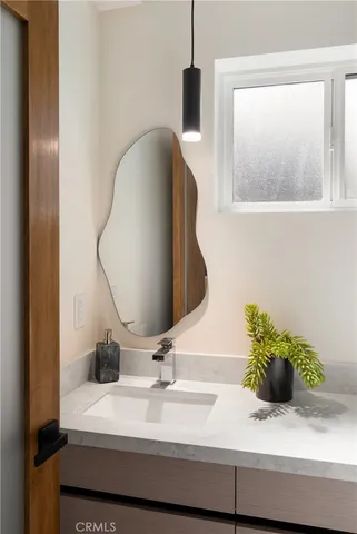 a bathroom with a sink and a mirror