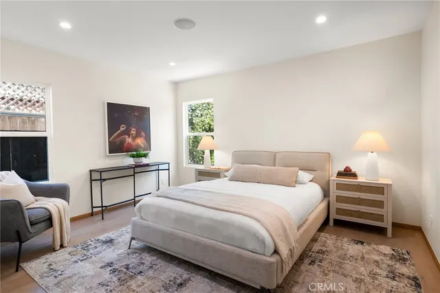 a bedroom with a bed a couch and dresser