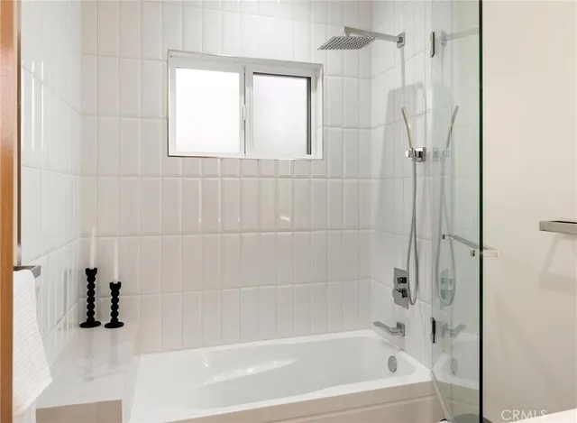 a bathroom with a shower and a bath tub