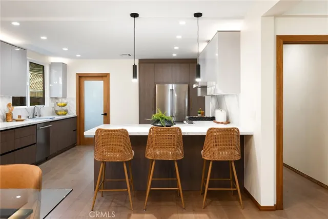 a dining room with furniture a window and kitchen view