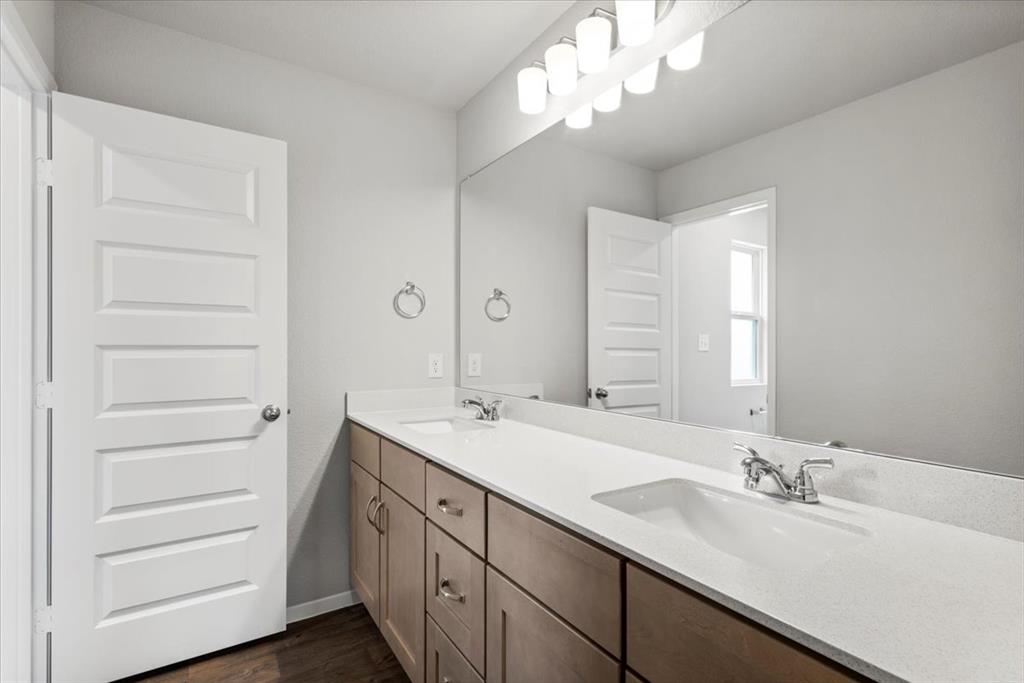 2707 Totley Road Manor, TX 78653 - Photo 31 of 39 Full bathroom featuring double vanity and dark wood finished floors