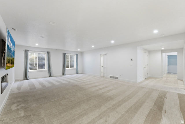108 West Monte Rosa Lane Midway, UT 84049 - Photo 35 of 48 Spacious room featuring light-colored carpeting, recessed lighting, and white walls