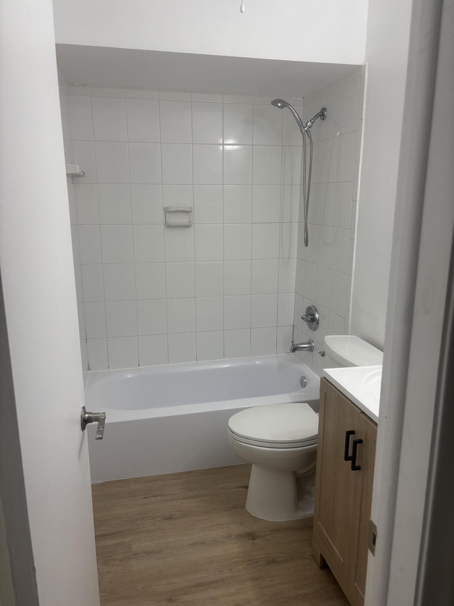 521 Northeast 45th Street Boca Raton, FL 33431 - Photo 13 of 17 a bathroom with a sink toilet and shower