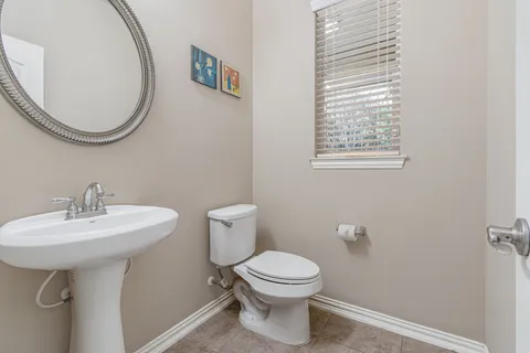 a bathroom with a sink a mirror and a toilet
