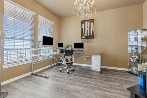 a view of a livingroom with workspace and a window