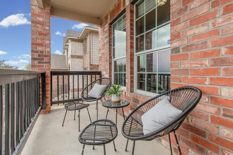 a view of balcony with couple of chairs