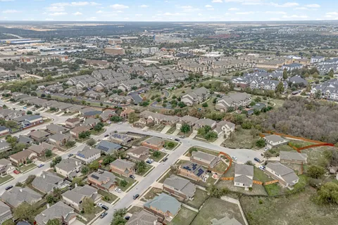 an aerial view of residential houses with outdoor space