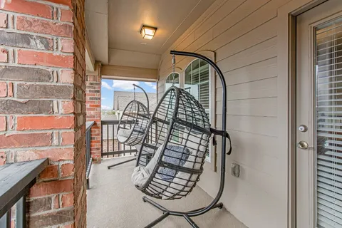 a view of staircase with railing and a potted plant