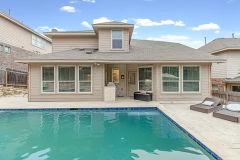 a front view of a house with a garden and patio