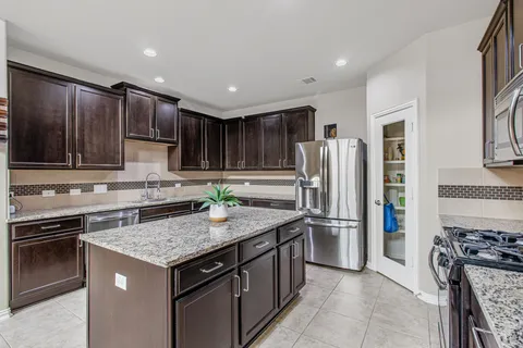 a kitchen with a stove sink and refrigerator
