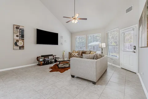 a living room with furniture and a flat screen tv