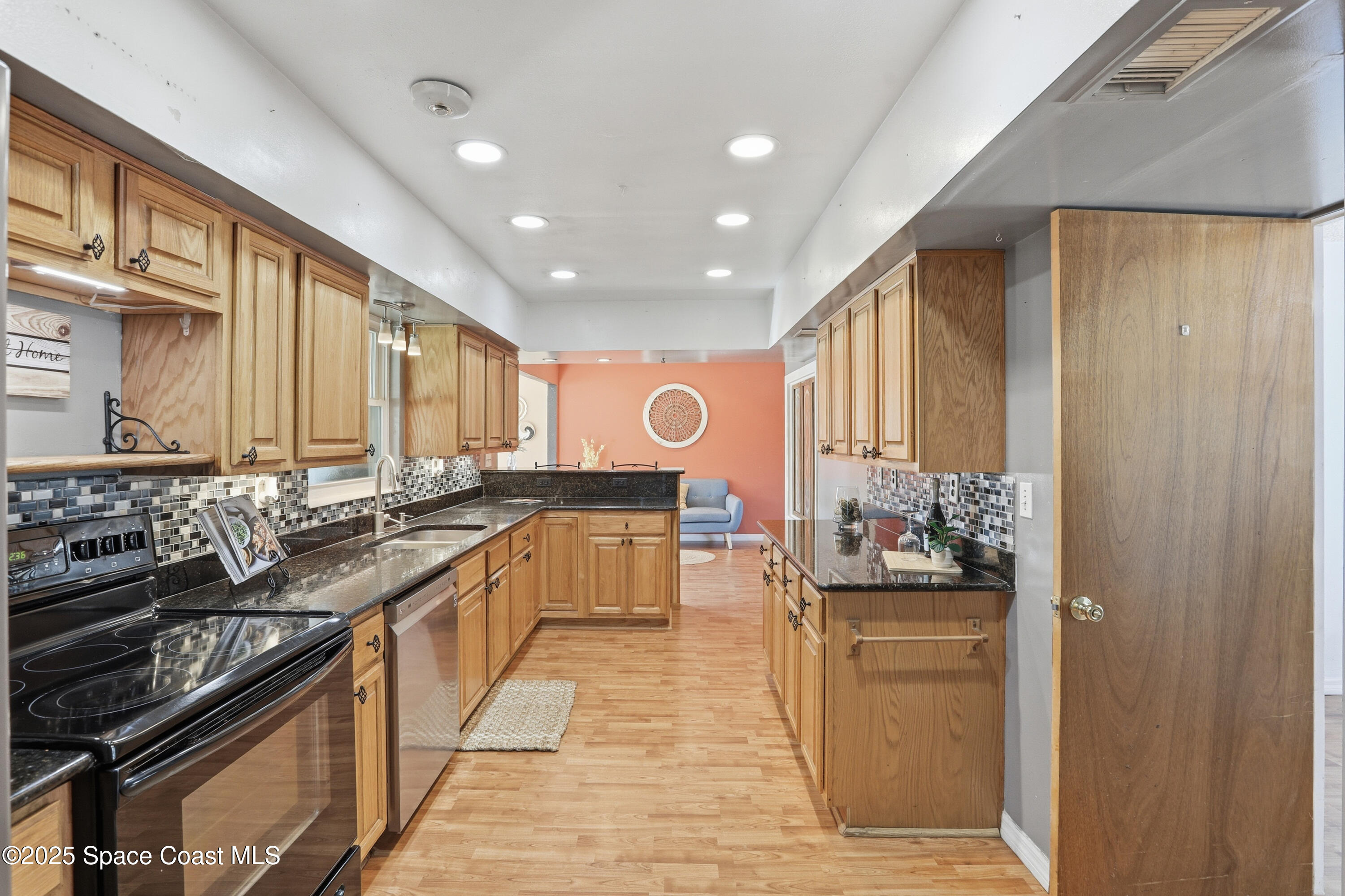 3929 Burkholm Road Mims, FL 32754 - Photo 13 of 51 a large kitchen with stainless steel appliances a large counter top a stove and a refrigerator