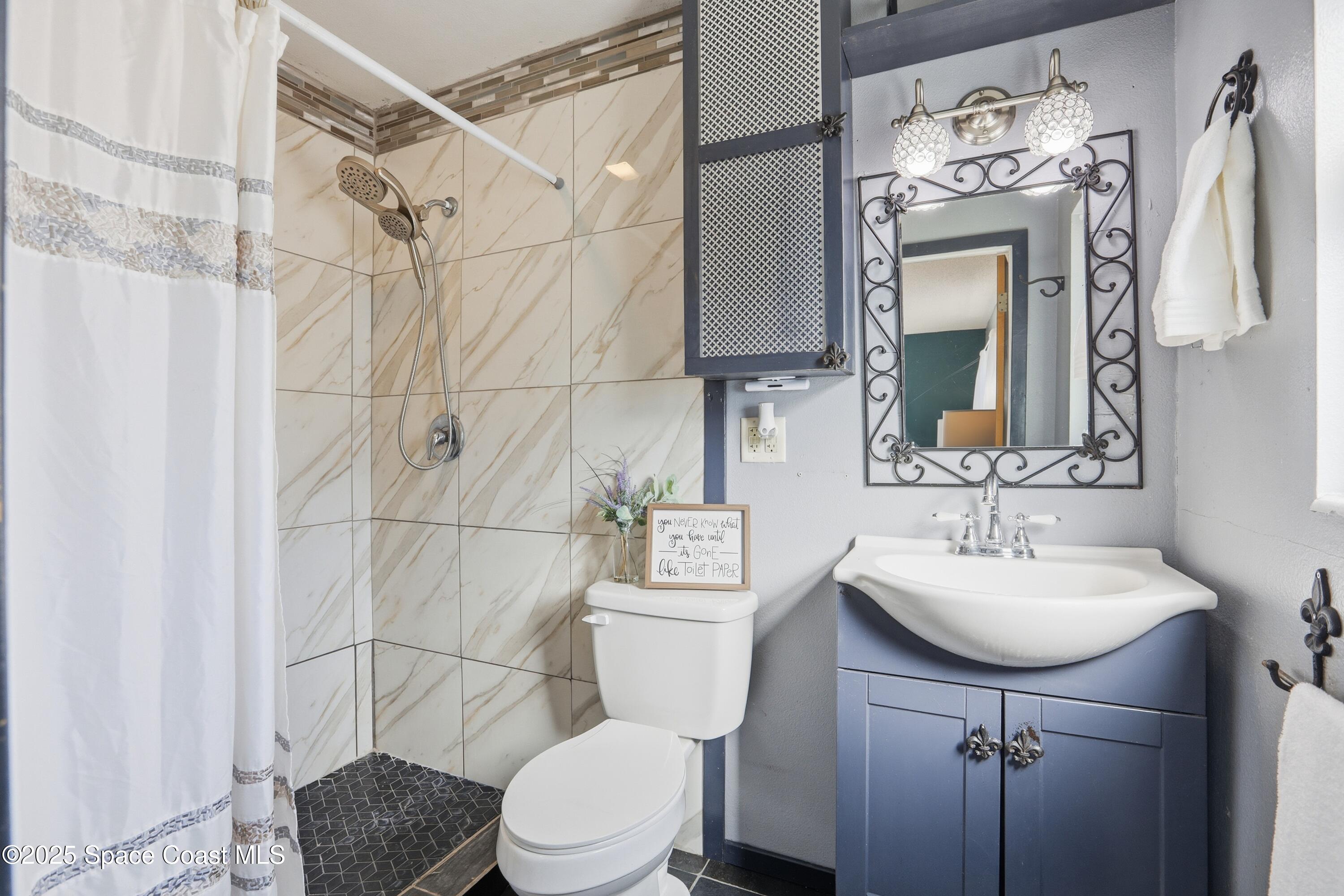 3929 Burkholm Road Mims, FL 32754 - Photo 21 of 51 a bathroom with a sink toilet and shower