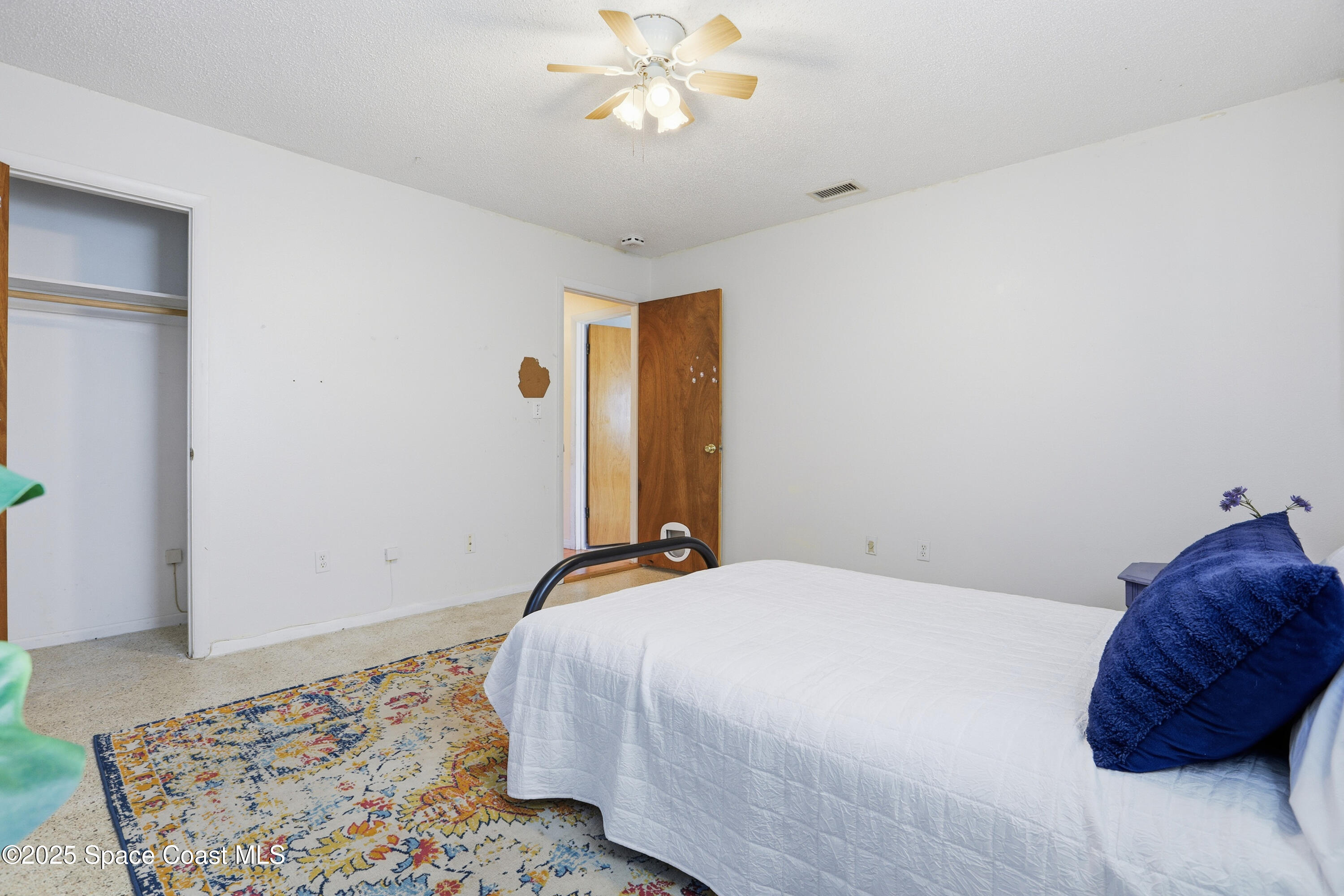3929 Burkholm Road Mims, FL 32754 - Photo 25 of 51 a bedroom with a bed window and a dresser