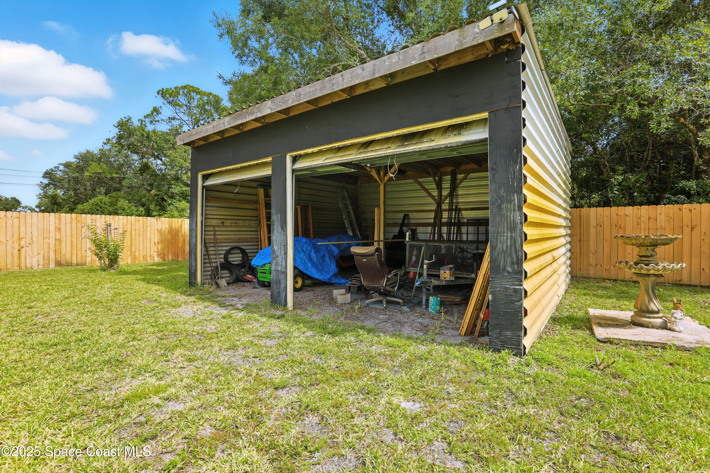 3929 Burkholm Road Mims, FL 32754 - Photo 40 of 51 a view of a chair and table in backyard of the house