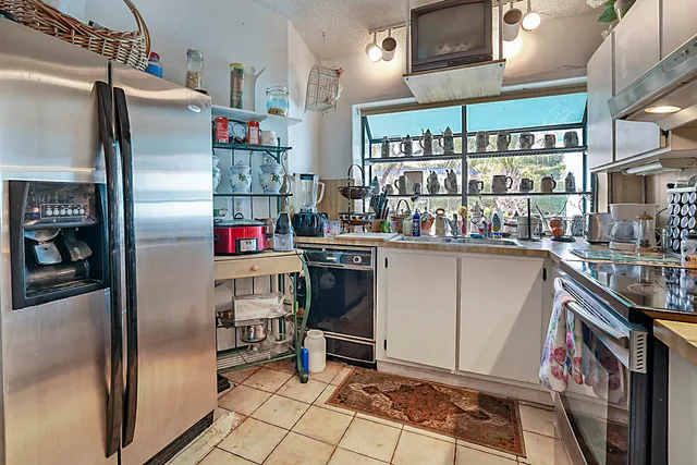 a kitchen with refrigerator and cabinets