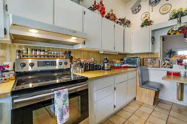 a kitchen with a stove and a refrigerator