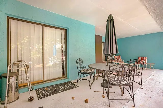 a view of a dining room with furniture and a window