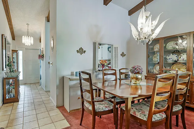 a view of a dining room with furniture and chandelier