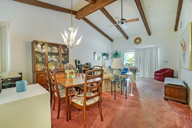 a very nice looking dining room with furniture and a chandelier