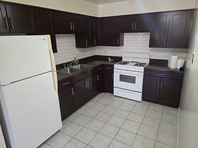 a kitchen with a stove top oven and cabinets