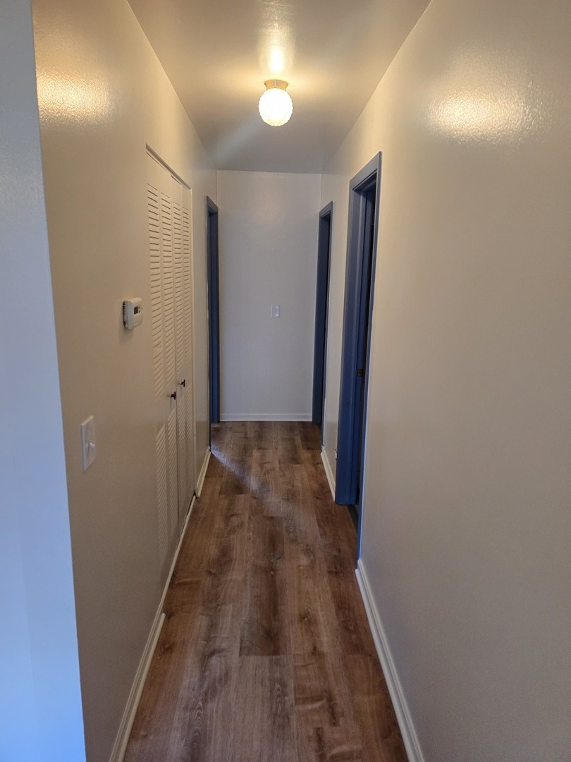 6882 West Touhy Avenue, Unit D Niles, IL 60714 - Photo 5 of 9 a view of a hallway with wooden floor