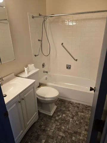a bathroom with a toilet sink and shower