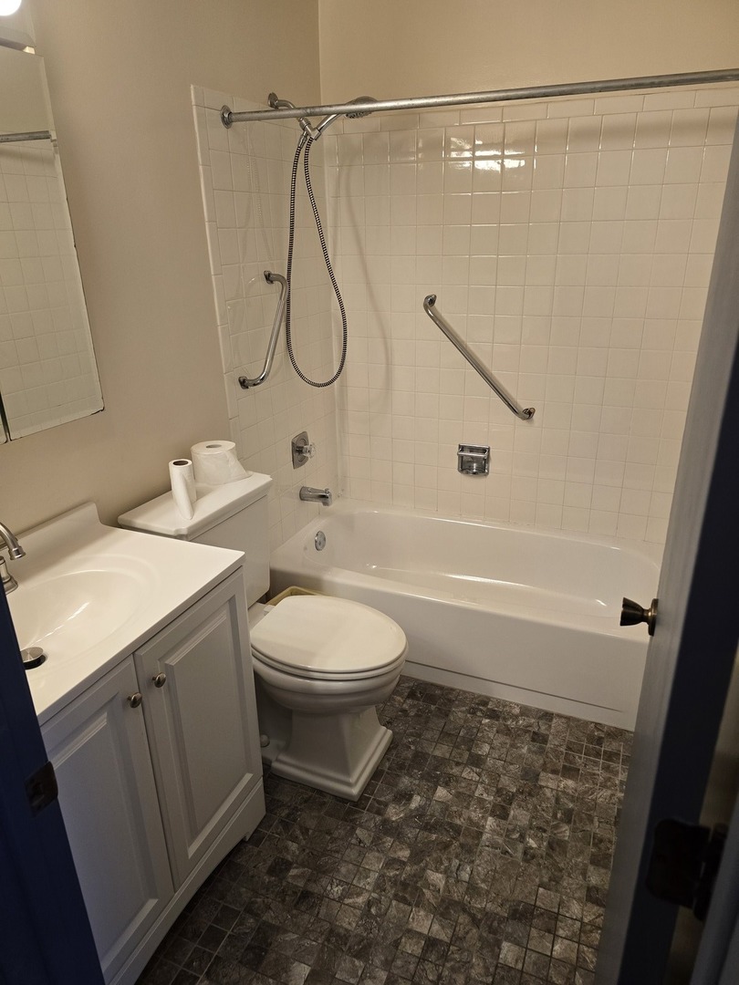 6882 West Touhy Avenue, Unit D Niles, IL 60714 - Photo 6 of 9 a bathroom with a toilet sink and shower