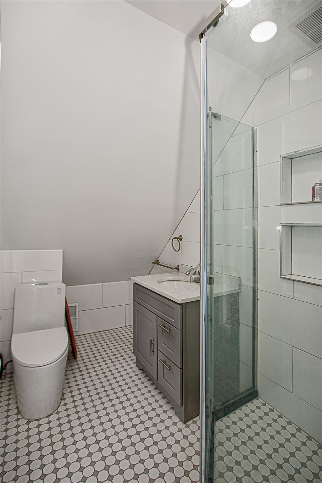80-63 87th Road Queens, NY 11421 - Photo 13 of 24 a bathroom with a toilet and a shower
