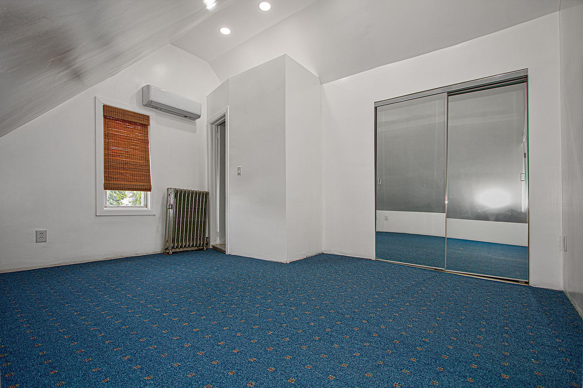 80-63 87th Road Queens, NY 11421 - Photo 15 of 24 an empty room with windows and closet