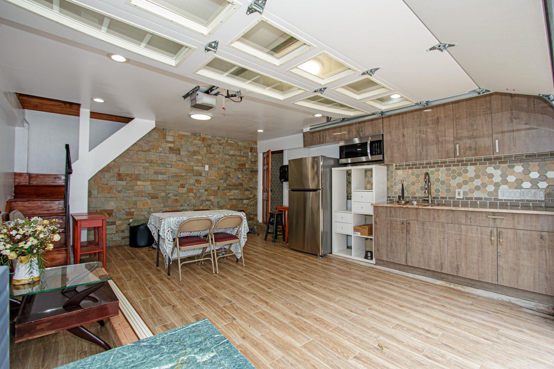 80-63 87th Road Queens, NY 11421 - Photo 21 of 24 a living room with stainless steel appliances kitchen island granite countertop furniture and a wooden floor