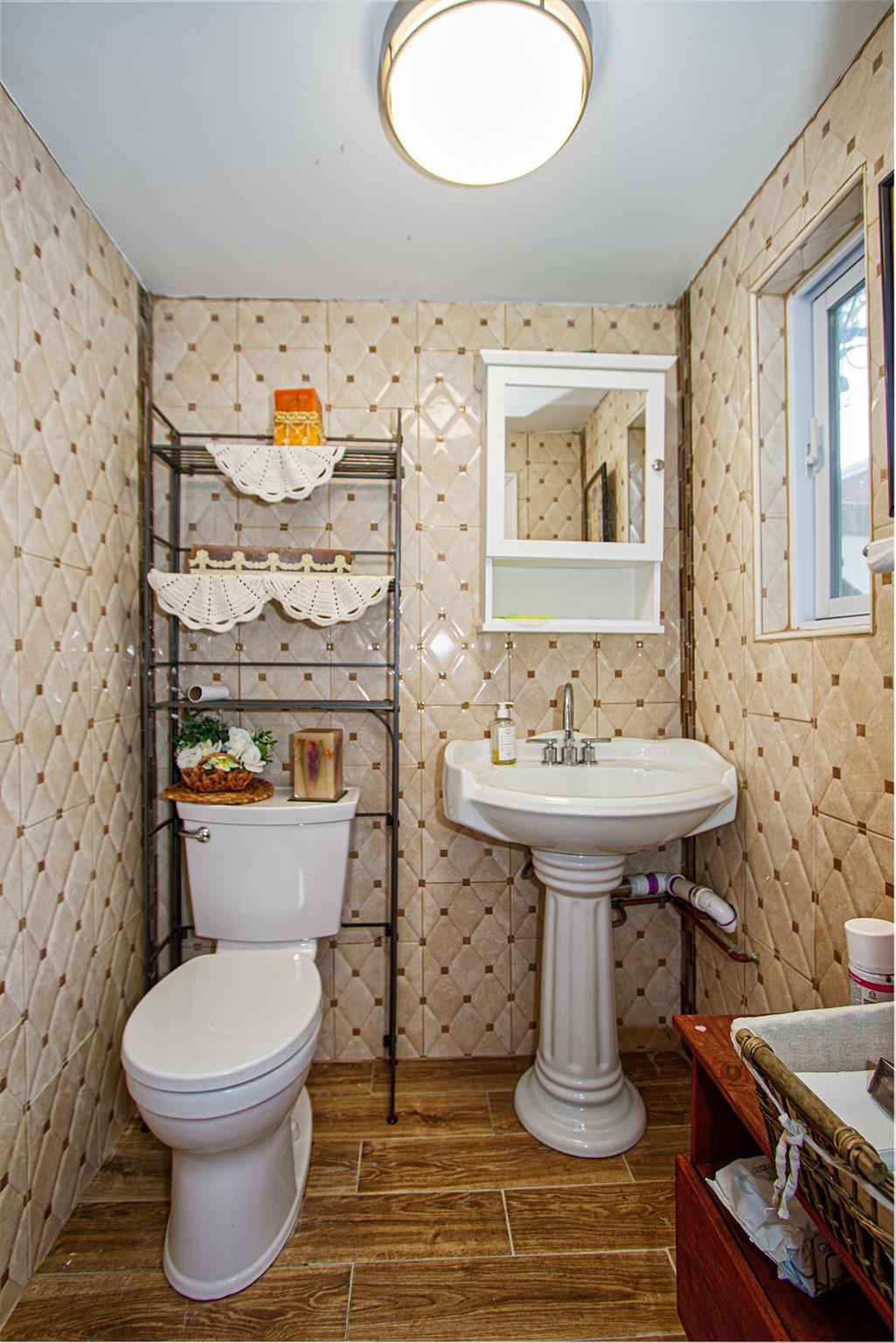 80-63 87th Road Queens, NY 11421 - Photo 22 of 24 a bathroom with a sink toilet and mirror