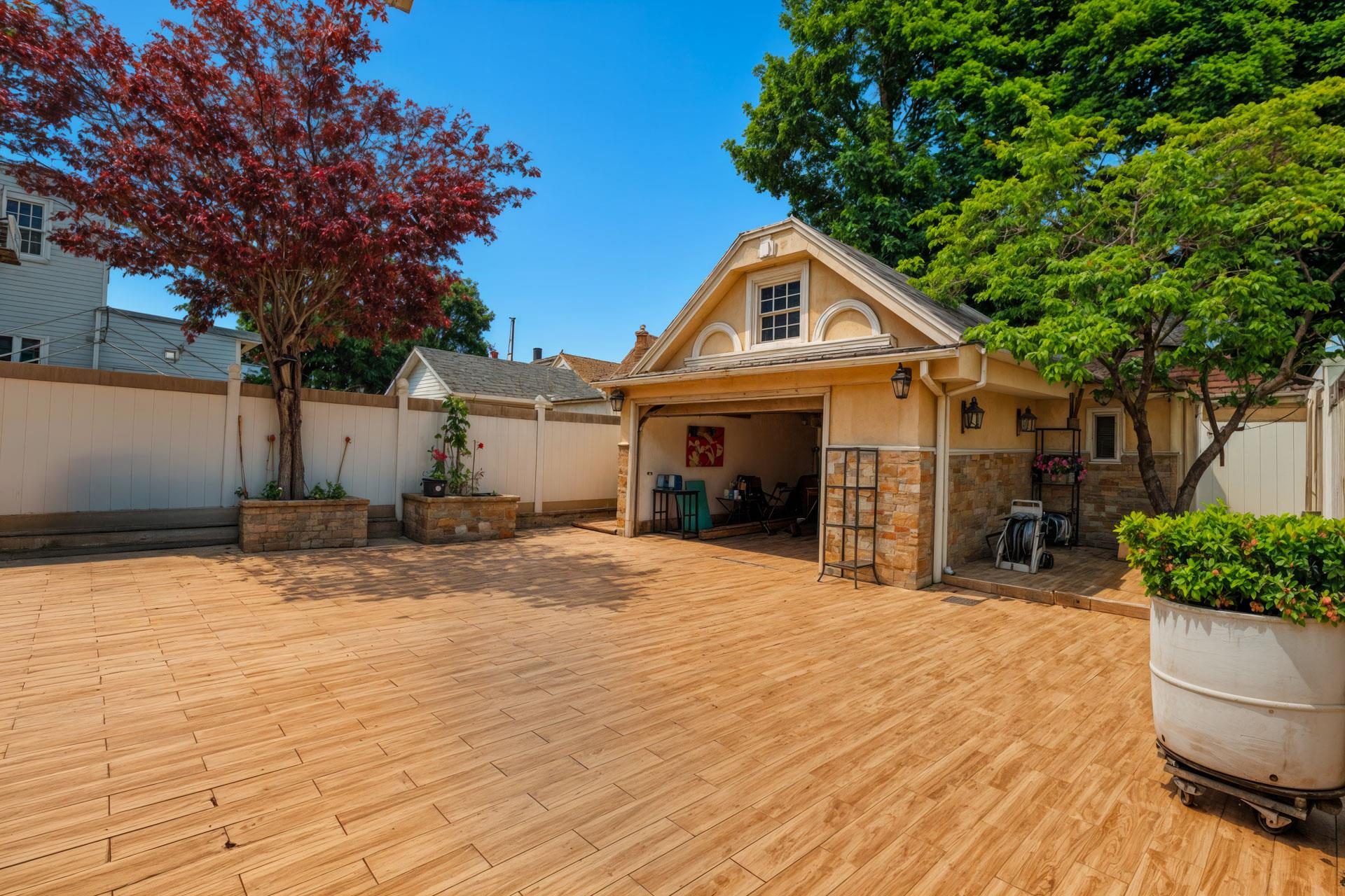 80-63 87th Road Queens, NY 11421 - Photo 23 of 24 a front view of a house with a yard and garage
