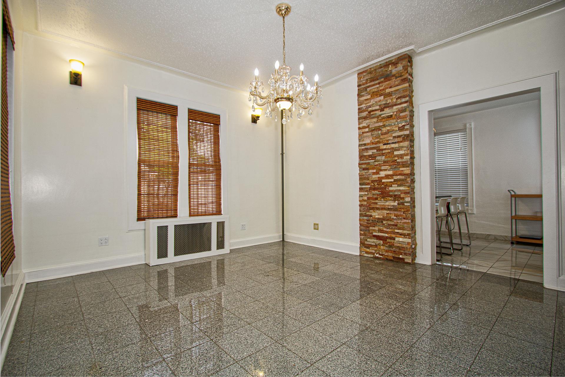 80-63 87th Road Queens, NY 11421 - Photo 5 of 24 a view of a livingroom with a chandelier fan and windows