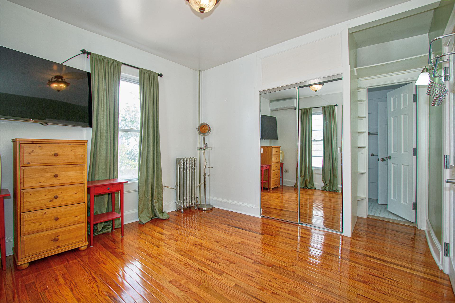 80-63 87th Road Queens, NY 11421 - Photo 8 of 24 wooden floor in an empty room with a window
