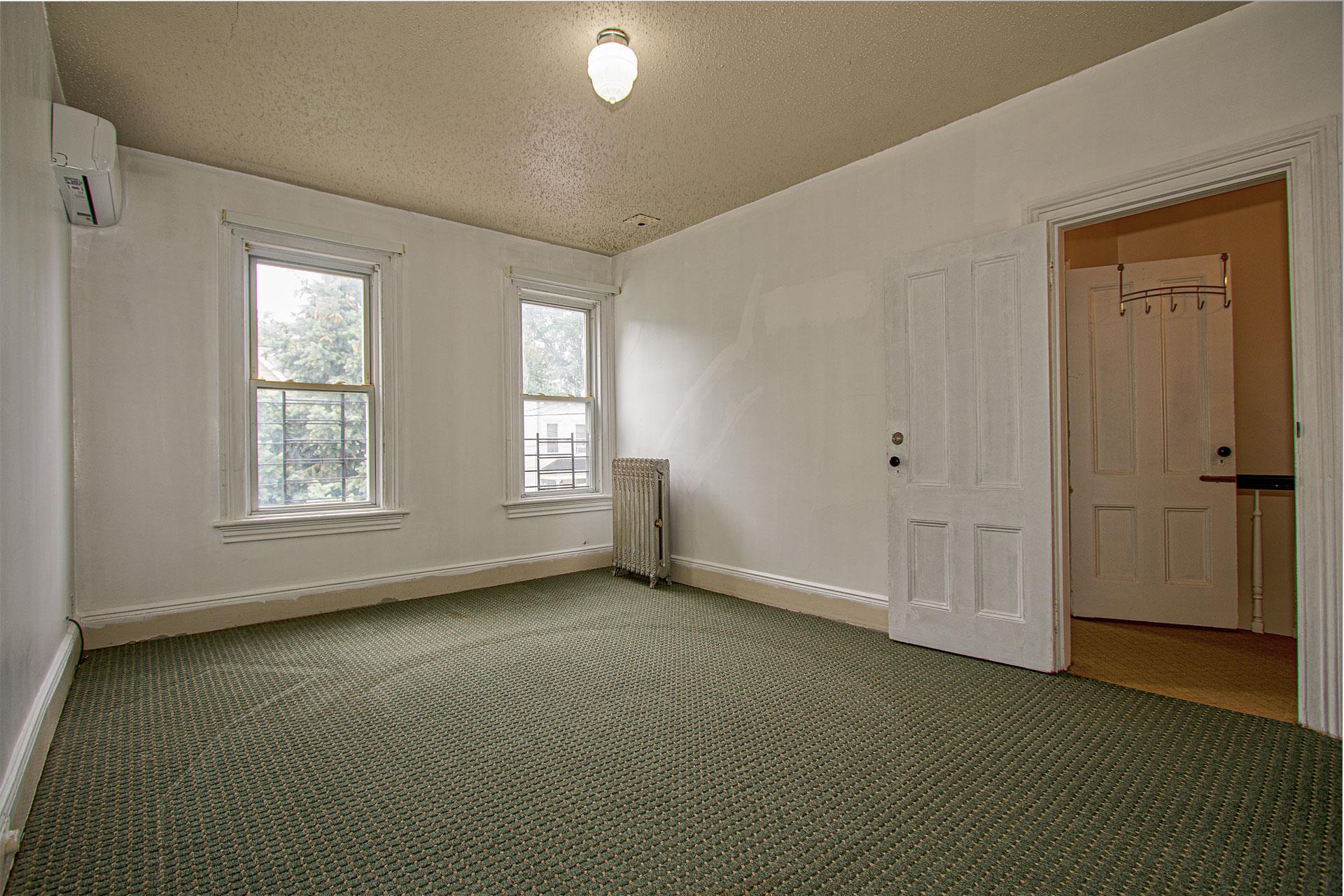 80-63 87th Road Queens, NY 11421 - Photo 10 of 24 a view of an empty room with a window